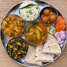 a metal plate topped with different types of food