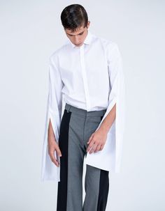 This minimal designed shirt is all about exaggerated proportions. The extended cuff and deep placket gives this shirt its elongated look. This shirt is made from a crisp white cotton poplin, It has a roomy shape enhanced by a dropped shoulder and squared hem. Its two piece sleeve have a front seam, deep placket and extended cuff. This shirt is perfect for layering: it will transform any look into a statement.Model's height is 188cm/6'2'' and he wears size M.Product Information 100% Cotton Crisp, Stylish Mens Suits, Drop Shoulder Shirt, Exaggerated Sleeves, Cotton Poplin, Wedding Outfit, Mens Suits, Drop Shoulder, White Cotton, Cool Outfits