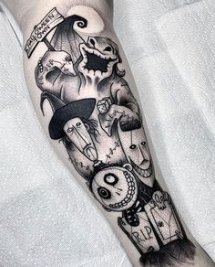 a black and white photo of a leg with some tattoos on it