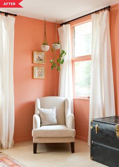 a white chair sitting in front of a window next to a trunk and potted plant