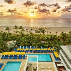 an aerial view of the pool and beach at sunset