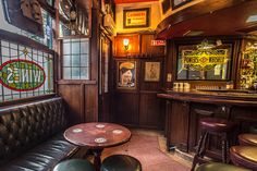 the inside of a bar with leather seats