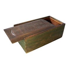 an old wooden box with a lid on it's side, open and empty