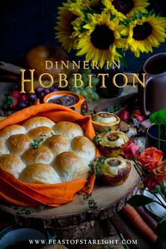 the cover of dinner in hobbiton, featuring rolls and carrots on a table