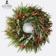 a christmas wreath with red and green foliage