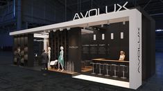 an exhibition stand with people walking around it and the words avoluxx on the wall