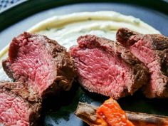 steak and carrots on a plate with cream cheese in the background, ready to be eaten