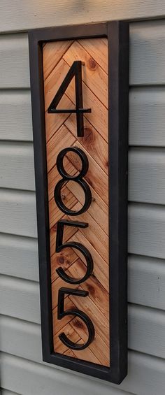 a house number sign mounted to the side of a building