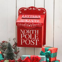 a red mailbox sitting next to christmas presents