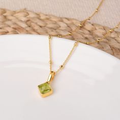 The Peridot Gem August Birthstone Necklace is a stunning and personalised piece, featuring a diamond-shaped cut Peridot gemstone on an 18" eco silver beaded satellite chain. Expertly handset into Sterling Silver, it boasts both elegance and durability, with the added benefit of powerful healing properties, believed to promote good health. Ideal as a unique birthday gift or a self-care treat. A birthstone card is included for the recipient. Peridot: positivity | emotional wellbeing | vitality We Luxury Peridot Jewelry For Gifts, Elegant Peridot Birthstone Necklace, Luxury Gold Peridot Jewelry, Elegant Green Peridot Birthstone Necklace, Luxury Gold Jewelry With Peridot, Elegant Gold Peridot Birthstone Necklace, Elegant Peridot Necklace For Gift, August Birthstone Necklace, Necklace Birthstone