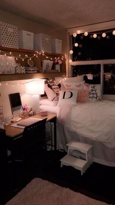 a bedroom with lights strung above the bed and desk in front of the window,