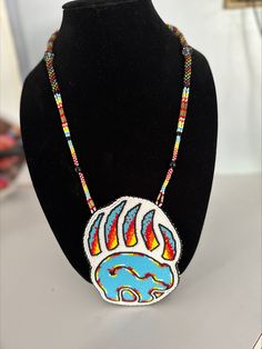 Handmade beaded Bear Claw medallion manufactured in Montana State Prison. Adjustable Beaded Necklace With Large Pendant, Artisan Multicolor Medallion Beaded Necklaces, Artisan Multicolor Medallion Beaded Necklace, Traditional Beaded Medallion Jewelry, Multicolor Beaded Medallion Jewelry, Bear Claw Jewelry, Beaded Bear, Native Beaded Medallions, Beaded Buffalo Medallion