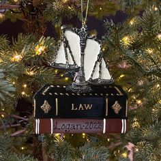 a law book ornament hanging from a christmas tree