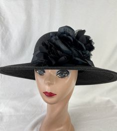 This one of a kind Black 4 inch brim Toyo Straw hat is trimmed with a large black silk and organza rose and 2 black satin roses, and black velvet leaves. The band is made with raw edged silk ribbon. The hat will fit 22- 22 5/8 inch head size with a sizing cord inside the band to adjust to your head size. NOTE: Please check the head size before purchase, I am happy to answer any questions you may have. There will be a 20% restocking fee for all returned hats. Black Hat For Kentucky Derby Church Event, Black Hats For Church And Kentucky Derby, Black Hat For Church And Kentucky Derby, Black Cloche Hat For Races, Black Top Hat With Wide Brim For Evening, Black Top Hat For Kentucky Derby Church Occasion, Black Wide Brim Costume Hat For Evening, Black Wide Brim Costume Hat For Evening Events, Black Top Hat For Kentucky Derby