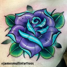 a purple rose with green leaves on it's chest is featured in this tattoo design