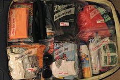 an open suitcase filled with various items including diapers, wipes and toiletries