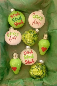 christmas ornaments with grin face painted on them in green and pink colors, including one for each ornament