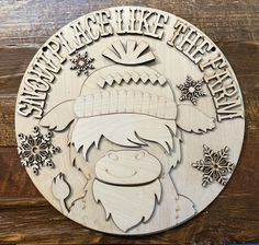 a wooden plaque with an image of a person wearing a hat and holding a snowflake