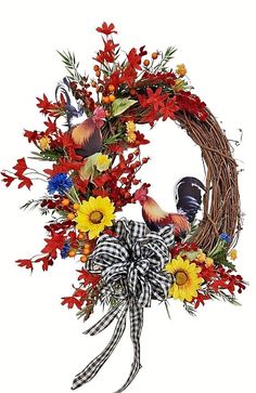 a wreath with flowers and birds on it