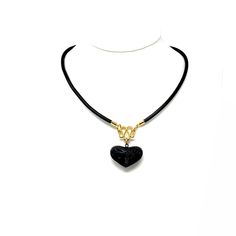 Elevate your wardrobe with a whisper of ethnic majesty with this masterfully handcrafted Barro Negro Ceramic Heart Necklace. Reflecting the soul of Mexican Necklace artistry, this piece showcases a hand-carved, heart-shaped Pottery Pendant, its surface graced by a sumptuous gold-plated finish that brings out the profound beauty of Oaxaca pottery. Embodying the allure of Artesanias Mexicanas, this unique necklace pays homage to the elation of joyas de barro. Each Ceramic Pendant is a testament to Handmade Adjustable Black Heart Necklace, Mexican Necklace Heart, Artisan Carved Black Necklace, Black Heart-shaped Bohemian Jewelry, Handmade Black Heart-shaped Beaded Necklace, Mexican Jewelry, Heart Shaped Necklace, Black Clay, Ceramic Pendant