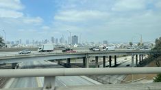 an overpass with cars driving on it and the city skyline in the back ground