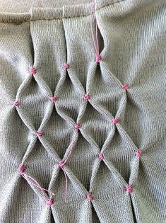 the fabric is stitched together with pink thread