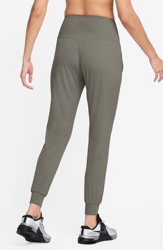 Legging-inspired joggers are made from soft fabric that you can feel with every bend or stretch, while moisture-wicking technology keeps you cool and comfy. 27 1/2" inseam; 8" leg opening; 13 1/2" front rise; 14" back rise (size Medium) Pull-on style Front slant pockets Lined gusset Dri-FIT moisture-wicking technology 63% nylon, 37% spandex Machine wash, line dry Imported Nike Relaxed Fit Moisture-wicking Joggers, Nike Sporty Tapered Leg Joggers, Nike Stretch Athleisure Sweatpants, Nike Athleisure Joggers With Comfort Waistband, Nike Stretch Casual Sweatpants, Nike Elastane Yoga Bottoms, Nike Joggers With Ribbed Waistband For Jogging, Nike Stretch Moisture-wicking Joggers, Nike Solid Color Athleisure Joggers