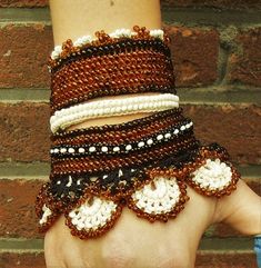 a woman's hand with several bracelets on it