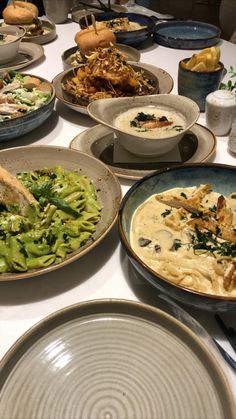 a table filled with plates and bowls of food