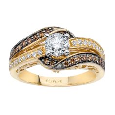 a gold ring with brown and white diamonds on it's sides, set in 18k yellow gold