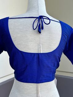 Royal Blue Color Readymade Blouse in Size 40 with padding. A dori or tie is added at the back of the blouse. Blouse has margin to open to size- 42 Item : BlouseSize : 40Color : Royal Blue Blouse Fabric : Raw SilkBlouse Fitting : Princess Cut Lining : Yes, it is fully lined Padded or Non-Padded : Padded Closure: Front Closure with hooks.Ready-to-Wear : YesDisclaimer - :-This is a Standard Size blouse. We do not guarantee perfect fit as every body and shape is different. Little or no alteration wo Elegant Long Sleeve Tie-back Blouse, Elegant Long Sleeve Tie Back Blouse, Blue Long Sleeve Blouse For Wedding, Elegant Long Sleeve Blue Blouse, Blue Unstitched Blouse Piece For Formal Occasions, Formal Blue Unstitched Blouse Piece, Blue Blouse Piece For Formal Occasions, Fitted Silk Blue Tops, Fitted Blue Silk Tops