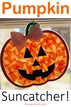 a paper pumpkin hanging from a window with the words suncather written below it