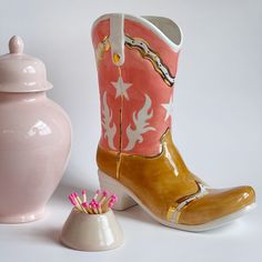 Description Giddy up for our ceramic cowboy boots! Sure to add a pop of color into any space, these boots boast a fun, western flair. These are waterproof and can be used as a vase, decoration, or simply as a gift. They are hand-poured in Oklahoma and hand-glazed by a Ruby Clay artist before being fired for a beautiful Cowboy Boot Ceramic Vase, Cowboy Boot Room Decor, Cowboy Boot Ceramic, Ceramic Cowboy Boot, Unique Clay Ideas, Cowgirl Home Decor, Vintage Glamour Decor, Cowboy Boot Vase, Boot Vase