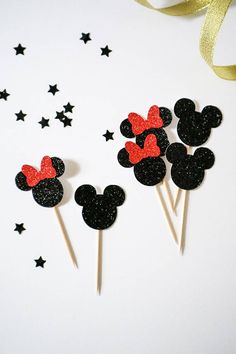 mickey and minnie mouse cupcake toppers on sticks with stars in the sky behind them