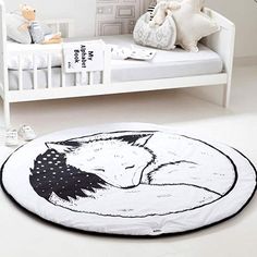 a black and white drawing of a sleeping fox on a round rug in a child's bedroom