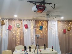 a photo studio setup up with lights and decorations on the curtained wall behind it