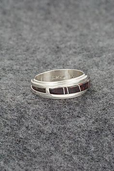 This onyx and sterling silver inlay ring was made by Navajo silversmith Wilbert Muskett Jr. The inside of the band is signed M and stamped sterling.Size: 7Length: 1/4"Free shipping on all orders! We ship with USPS and always include tracking. All orders ship within a day of payment.Returns are accepted up to 30 days after you receive your order. Just send us a message. Our shop offers cash back or store credit. The item must be returned in new condition. Formal Sterling Silver Rings With Inlay, Sterling Silver Inlay Ring, Sterling Silver Inlay Ring For Anniversary, Sterling Silver Inlay Jewelry For Anniversary, Sterling Silver Jewelry With Inlay For Anniversary, Anniversary Sterling Silver Jewelry With Inlay, Bear Carving, Squash Blossom, Bolo Tie