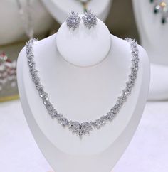 A beautiful two-piece bridal jewelry set with an incredible sparkle! Adorned with intricately faceted cubic zirconia that capture the light from every angle with a perfectly translucent appeal, the pieces are platinum / 14K rose gold plated for a flawless finish which enhances the intricate detailing and conveys a modern take on old elegance. Necklace: 17" (approx. 43) long with a secure fold-over closure Earrings: 1" (approx. 2.5cm) and come with sturdy backs Available in Silver and Rose Gold f Bridal Jewelry Set, Luxury Bridal, Cheap Jewelry, Wedding Jewelry Sets, Bridal Jewelry Sets, Wedding Necklace, Quality Jewelry, Rose Gold Plates, Or Rose