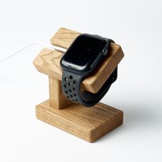 an apple watch is attached to a wooden stand