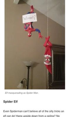 an elf hanging from the ceiling with spiderman decorations on it's head and arms