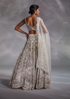 Editor's Note Featuring an off-white hand-embellished blouse, lehenga and solid dupatta with embroidered border Color: Off-white Fabric: Crushed organza, silk and organza Fit type: Blouse: fitted Neckline: V-neckline Components: Lehenga, blouse and dupatta Occasion: Wedding Care: Dry Clean Only About the Designer The crux and essence of the label, Divya Aggarwal, is to challenge and revamp the face of ordinary traditional wear while being customer oriented. Driven by the values of individuality White Pearl Blouse, Lehenga Silk, Scallop Neckline, Sheer Dupatta, Leaf Sleeve, Blouse Lehenga, Blouse Yoke, Padded Blouse, Embellished Blouse