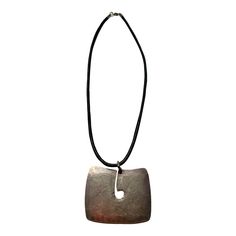 This is a hand-hammered reproduction of a rare design that Harry Bertoia did at the Bertoia Studio in the 1970s, Bertoia toyed with creating a complete line of jewelry since the 1940s but it never materialized. This piece is one of a limited edition of 100 authorized by the Bertoia Foundation.Dimensions - Leather cord 19" Pendant 1 3/4" H x 2 1/4" W Artisan Metal Jewelry For Formal Occasions, Artisan Jewelry With Large Rectangular Pendant, Vintage Hammered Jewelry For Gifts, Hammered Vintage Necklace As Gift, Vintage Hand Forged Jewelry For Formal Occasions, Vintage Hammered Necklaces As Gift, Vintage Hammered Necklaces For Gifts, Modern Collectible Rectangular Jewelry, Modern Handmade Rectangular Jewelry