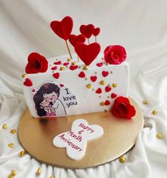 a cake decorated with hearts and flowers on a table