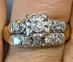 two wedding rings on top of each other, with diamonds in the middle and bottom