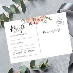 the wedding rsp card is laying on top of some flowers and greenery next to it