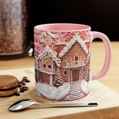 a pink coffee mug sitting on top of a wooden cutting board next to a cookie