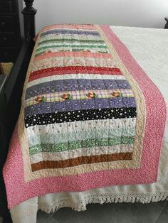 an image of a bed with a quilt on it