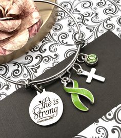 This listing is for a beautiful, handmade, lime green ribbon bracelet. Please contact me if you need a different ribbon color. * The 1-inch pendant is laser cut, silver, and reads: She is Strong / Proverbs 34:25 * Cause ribbon charm is sterling silver plate and acrylic. It measures an inch tall. * Also included is a small, silver plated encouragement charm of your choice. * Swarovski crystal charm to compliment your ribbon. * The silver bangle bracelet is adjustable in size by squeezing or stret Personalized Green Bracelets For Mother's Day, Personalized Adjustable Green Jewelry, Personalized Green Bracelets As Gifts, Handmade Green Jewelry For Personalized Gifts, Green Charms Jewelry For Friendship, Hypoallergenic Green Bracelets As Gift, Customizable Green Bracelet Jewelry, Cadmium-free Green Jewelry For Gifts, Green Nickel-free Bracelets For Gifts