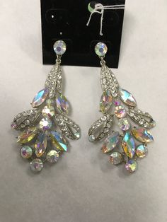 Featuring a 3.5” drop, these oval and round stones showcase a multi mix of AB-crystal and rhinestone adornment and are set in silver-tone post earrings. Cheap Multicolor Rhinestone Earrings, Luxury Statement Crystal Earrings With Rhinestones, Luxury Clip-on Earrings With Sparkling Stones For Evening, Luxury Bohemian Drop Earrings, Luxury Dazzling Bling Earrings, Luxury Crystal Embellished Earrings For Evening, Luxury Crystal Embellished Drop Earrings, Luxury Pierced Crystal Drop Earrings, Luxury Crystal Embellished Chandelier Earrings For Women