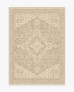 a beige rug with an intricate design on it